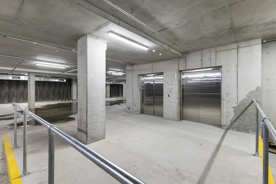 Two stainless-steel lifts in the basement car park lobby