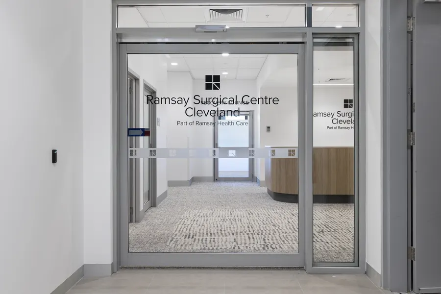 Glass entry doors to Ramsay Surgical Centre Cleveland, with its reception beyond