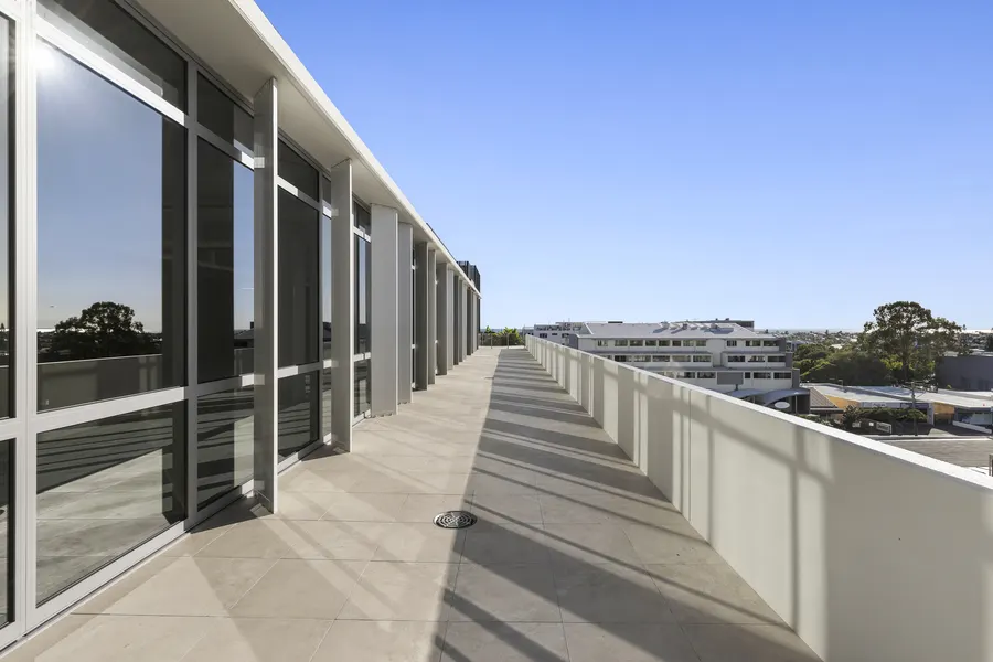 A covered terrace running along the glazed upper level, with views over Cleveland